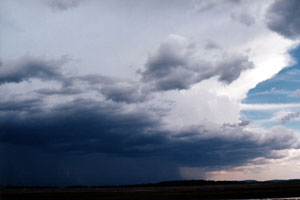 Heavy rain and hail begins to fall from the first storm.